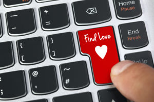 Computer keyboard key with find love and heart icon concept for online internet dating